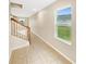 Hallway with stairs, tile flooring, and a view of the backyard at 4269 Desert Rose Ave, Kissimmee, FL 34746