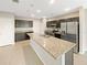 Modern kitchen with dark cabinets, granite countertops, and stainless steel appliances at 4269 Desert Rose Ave, Kissimmee, FL 34746