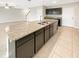 Kitchen island with granite countertop and double sink at 4269 Desert Rose Ave, Kissimmee, FL 34746