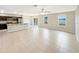 Open floor plan with tile flooring connecting the kitchen and living areas at 4269 Desert Rose Ave, Kissimmee, FL 34746