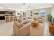 Open living room and kitchen with island and neutral color palette at 4269 Desert Rose Ave, Kissimmee, FL 34746