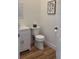 Clean bathroom with white vanity, toilet and wood-look flooring at 4726 Combahee Ln, Orlando, FL 32837