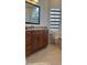 Bathroom with wood vanity, granite countertop, and tile floor at 4726 Combahee Ln, Orlando, FL 32837