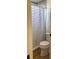 Updated bathroom with gray tile shower and wood-look flooring at 4726 Combahee Ln, Orlando, FL 32837