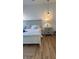 Main bedroom with king-size bed, light gray wood furniture, and wood flooring at 4726 Combahee Ln, Orlando, FL 32837