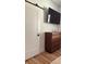 Bedroom with barn door, wood dresser, and large TV at 4726 Combahee Ln, Orlando, FL 32837