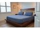 Main bedroom with wood platform bed and neutral color scheme at 4726 Combahee Ln, Orlando, FL 32837