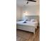 Spacious bedroom with king-size bed, light gray furniture, and ceiling fan at 4726 Combahee Ln, Orlando, FL 32837