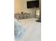 Bedroom with king bed, gray pillows, and large flat-screen TV at 4726 Combahee Ln, Orlando, FL 32837
