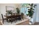 Bright dining room features a large wooden table with seating for eight and an area rug at 4726 Combahee Ln, Orlando, FL 32837