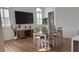 Dining area with four-chair table, large TV, and wood floors at 4726 Combahee Ln, Orlando, FL 32837