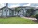 Green house exterior with palm trees and landscaped yard at 4726 Combahee Ln, Orlando, FL 32837