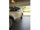 Garage with dark-grey tile flooring and a white SUV at 4726 Combahee Ln, Orlando, FL 32837
