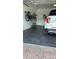 Garage with dark-grey tile flooring, bike storage, and a white SUV at 4726 Combahee Ln, Orlando, FL 32837