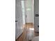 Bright hallway with wood-look flooring and white doors at 4726 Combahee Ln, Orlando, FL 32837