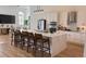 Modern white kitchen with large island, stainless steel appliances, and quartz countertops at 4726 Combahee Ln, Orlando, FL 32837