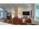 Spacious living room with orange couch and large TV at 4726 Combahee Ln, Orlando, FL 32837