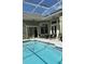 Screened pool with tiled coping and patio furniture at 4726 Combahee Ln, Orlando, FL 32837
