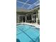 Screened pool with tiled coping and patio furniture at 4726 Combahee Ln, Orlando, FL 32837