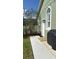 Side yard with a walkway, grill, and landscaping at 4726 Combahee Ln, Orlando, FL 32837