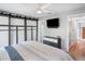 Bright bedroom with barn door and large TV at 4807 Loretta Ln, Orlando, FL 32821