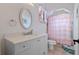 Charming bathroom with a ruffled shower curtain and updated vanity at 5251 Carson St, St Cloud, FL 34771