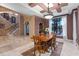 Formal dining room with wood table and chairs, adjacent to entryway and staircase at 5251 Carson St, St Cloud, FL 34771