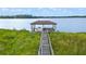 Wooden dock with covered area and boat on lake at 5251 Carson St, St Cloud, FL 34771