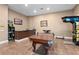 Game room features a pool table, bar, and arcade game at 5251 Carson St, St Cloud, FL 34771