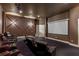 Luxurious home theater with comfortable seating and large projection screen at 5251 Carson St, St Cloud, FL 34771