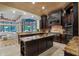 Spacious kitchen boasts granite counters, dark cabinetry, and an island at 5251 Carson St, St Cloud, FL 34771