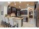 Gourmet kitchen featuring granite countertops, dark wood cabinetry, and an island at 5251 Carson St, St Cloud, FL 34771