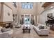 Spacious living room with high ceilings, a fireplace, and large windows at 5251 Carson St, St Cloud, FL 34771