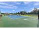 Tennis and basketball court with expansive green space and a large home in the background at 5251 Carson St, St Cloud, FL 34771