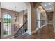 Grand upper hallway with elegant staircase and high ceilings at 5251 Carson St, St Cloud, FL 34771
