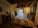 Bedroom with four-poster bed and access to a private balcony at 5302 Burning Tree Dr # F-02-2, Orlando, FL 32811