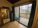 Bedroom with access to balcony featuring wood floors and view of trees at 5302 Burning Tree Dr # F-02-2, Orlando, FL 32811