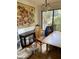 Simple dining room with light wood table and chairs, and artwork at 5302 Burning Tree Dr # F-02-2, Orlando, FL 32811