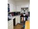 Small kitchen with white cabinets and stainless steel appliances at 5302 Burning Tree Dr # F-02-2, Orlando, FL 32811