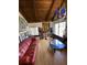 Living room with hardwood floors, red leather couch, and wood ceiling at 5302 Burning Tree Dr # F-02-2, Orlando, FL 32811