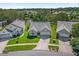 Aerial view of three houses and a canal in a residential neighborhood at 693 Rochester Ct, New Smyrna Beach, FL 32168