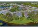 Aerial view showing home, lake, and neighborhood at 693 Rochester Ct, New Smyrna Beach, FL 32168