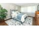 Cozy bedroom with wood floors, and a blue comforter at 706 Drywood Ave, Fern Park, FL 32730