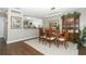 Formal dining room adjacent to the kitchen, features hardwood floor and a wooden table set at 706 Drywood Ave, Fern Park, FL 32730