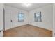 Bright bedroom featuring two windows and a door at 747 Mcintyre Ave, Winter Park, FL 32789