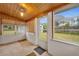 Bright screened porch with wood ceiling and backyard view at 747 Mcintyre Ave, Winter Park, FL 32789