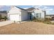 Gray one-story house with white garage door and landscaping at 7518 Sw 77Th Ave, Ocala, FL 34481