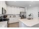Modern kitchen with white cabinets and stainless steel appliances at 7518 Sw 77Th Ave, Ocala, FL 34481