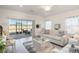 Spacious living room features a comfy sofa and a large window at 7518 Sw 77Th Ave, Ocala, FL 34481
