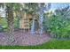 Wooden treehouse playset with rock climbing wall in lush backyard at 753 Renegade Ln, Port Orange, FL 32127